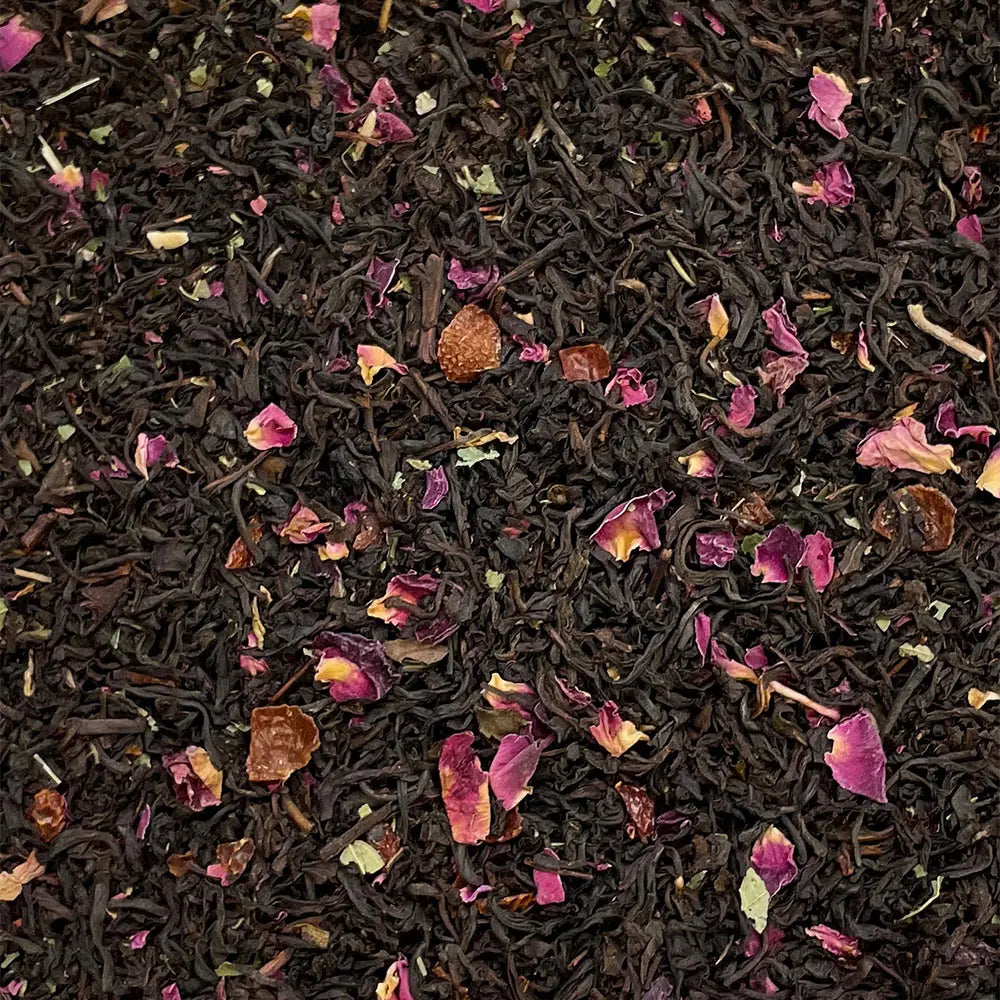 Loose leaf Queen Mary's Rose Garden tea by High Teas, showcasing fragrant rose petals and delicate tea leaves in a natural setting.
