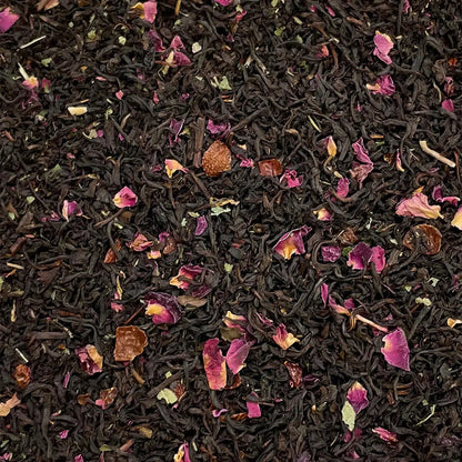 Loose leaf Queen Mary's Rose Garden tea by High Teas, showcasing fragrant rose petals and delicate tea leaves in a natural setting.