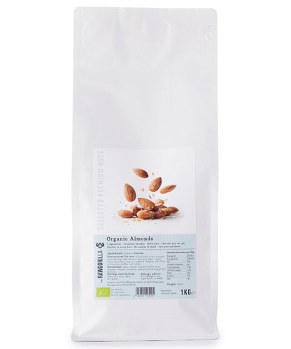 Raw organic almonds from RAWGORILLA, 1kg package, displayed in a clear bowl on a wooden surface, highlighting fresh, whole nuts.