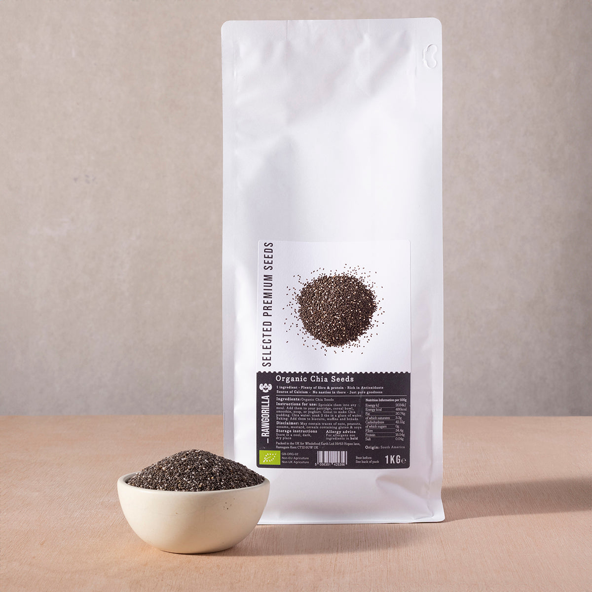 Organic chia seeds in a clear jar from RAWGORILLA, showing small dark seeds on a white background.