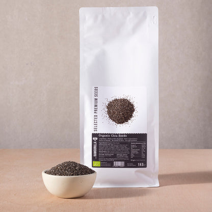 Organic chia seeds in a clear jar from RAWGORILLA, showing small dark seeds on a white background.