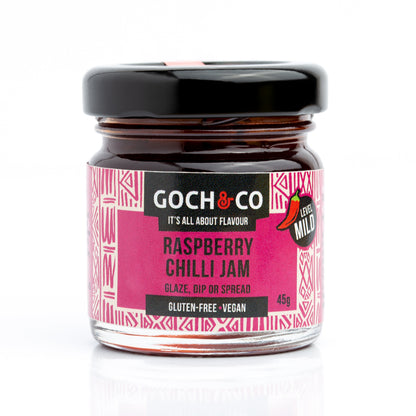 Small jar of Goch & Co Raspberry Chilli Jam showing the jar with pink raspberry jam and red chilli pieces inside.