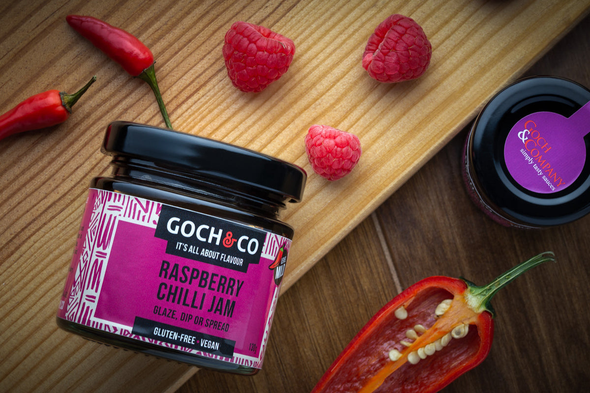 Bright image of Goch & Co Raspberry Chilli Jam jar showing the label and vibrant red jam inside, highlighting its fruity and spicy appearance.