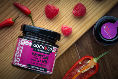 Bright image of Goch & Co Raspberry Chilli Jam jar showing the label and vibrant red jam inside, highlighting its fruity and spicy appearance.