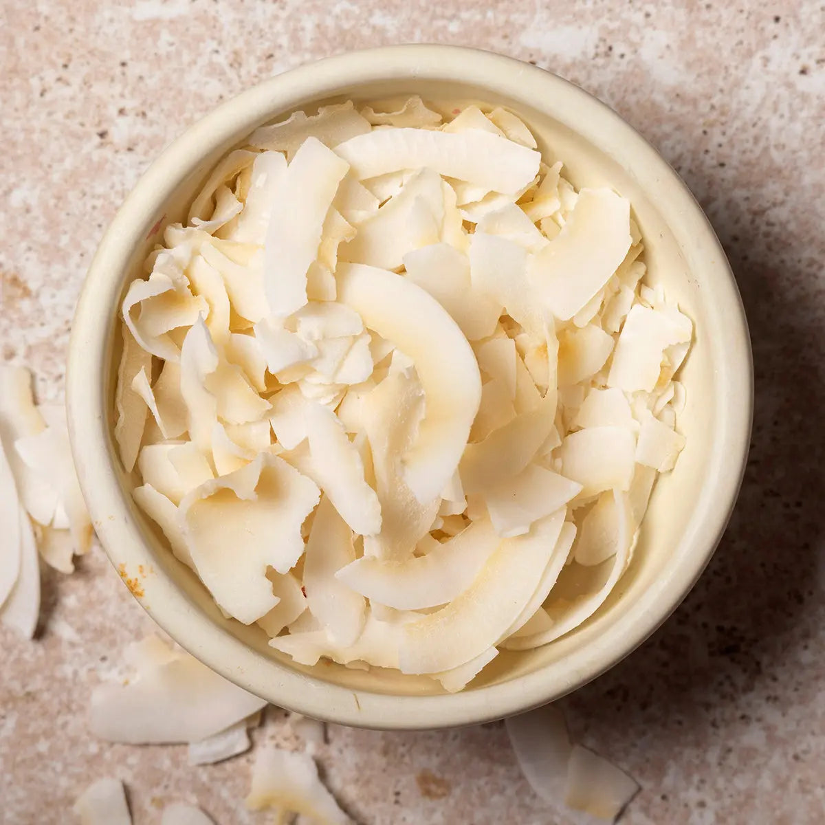 Raw coconut slice from Whole Food Earth, dried fruit piece showcasing its natural texture and shredded coconut appearance.
