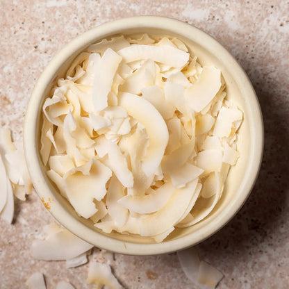 Raw coconut slice from Whole Food Earth, dried fruit piece showcasing its natural texture and shredded coconut appearance.