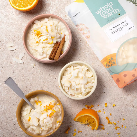 Fresh raw coconut slice from ArtisanBox displayed on a wooden table with a natural, healthy lifestyle setting.