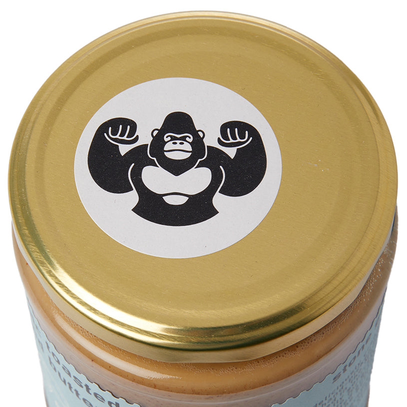 Organic toasted almond butter by RawGorilla in a jar, showcasing creamy texture and natural almond color.