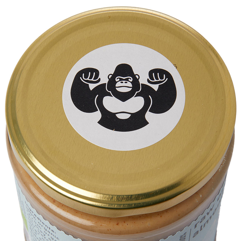 Creamy raw organic almond butter in a jar from RawGorilla, made with Whole Food Earth, showcasing its smooth, natural texture.