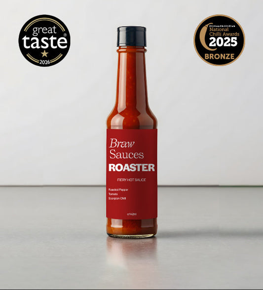 Braw Sauces Roaster Hot Sauce bottle with label featuring fiery design, set against a backdrop of a roasting scene and GTA 2026 logo