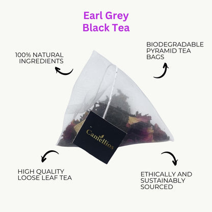 Cup of Camellios Earl Grey tea with tea leaves and a teapot, showcasing the aromatic infusion in a cozy setting.