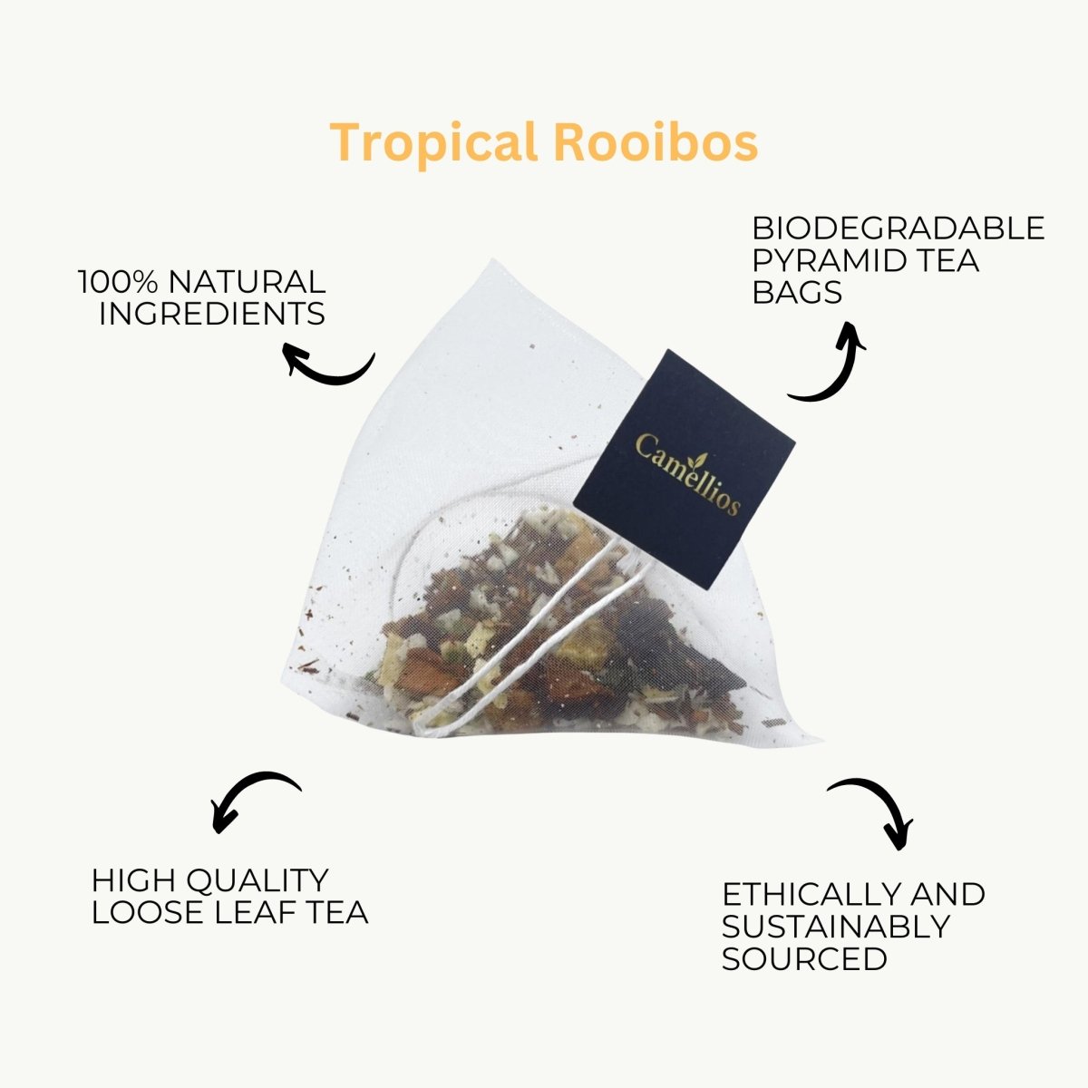 Camellios Tropical Rooibos tea in a clear glass cup with dried rooibos leaves and tropical fruit slices.