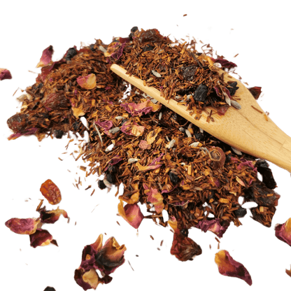 Cup of Porter Hill Tea Company's Rooibos De Provence herbal tea with dried rooibos leaves and herbs in a clear glass cup.