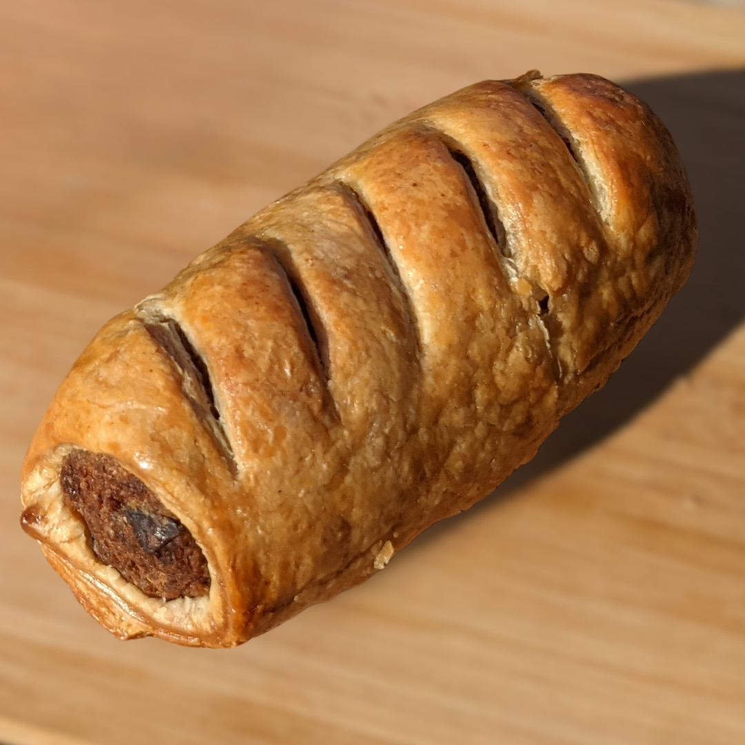 A sausage roll made with Bangin' Sausage Mix by Another Way, featuring a golden-brown pastry with visible sausage filling.