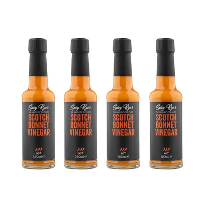 Four bottles of Spicy Ryes Scotch Bonnet Vinegar with vibrant labels and red Scotch Bonnet peppers on the packaging.