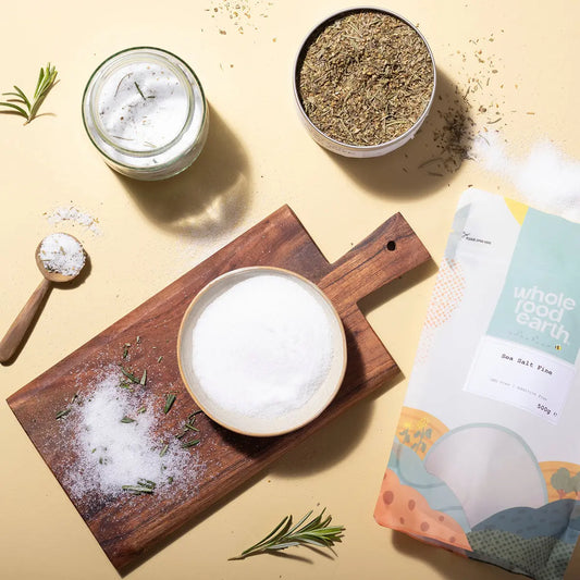 Fine sea salt from ArtisanBox shown in a natural setting with salt crystals and a rustic background.