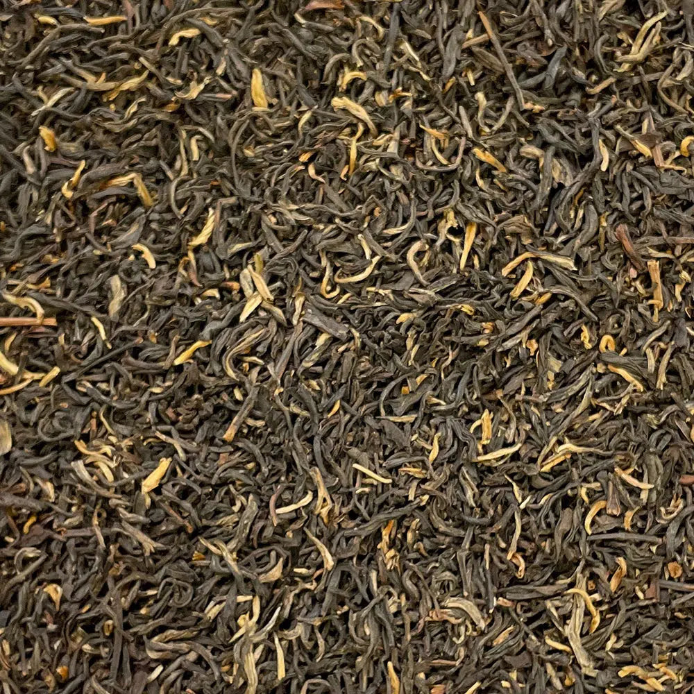 Loose leaf Yunnan Imperial "Gold Tip" Shanghai Breakfast Tea by High Teas, showcasing golden tips and rich amber leaves.