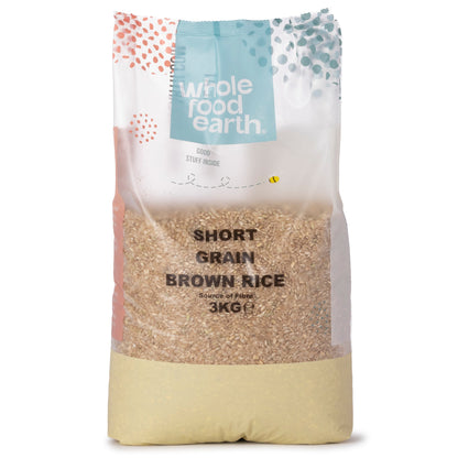 Whole Food Earth short grain brown rice in a 3kg bag, showing the uncooked rice grains in a natural setting.
