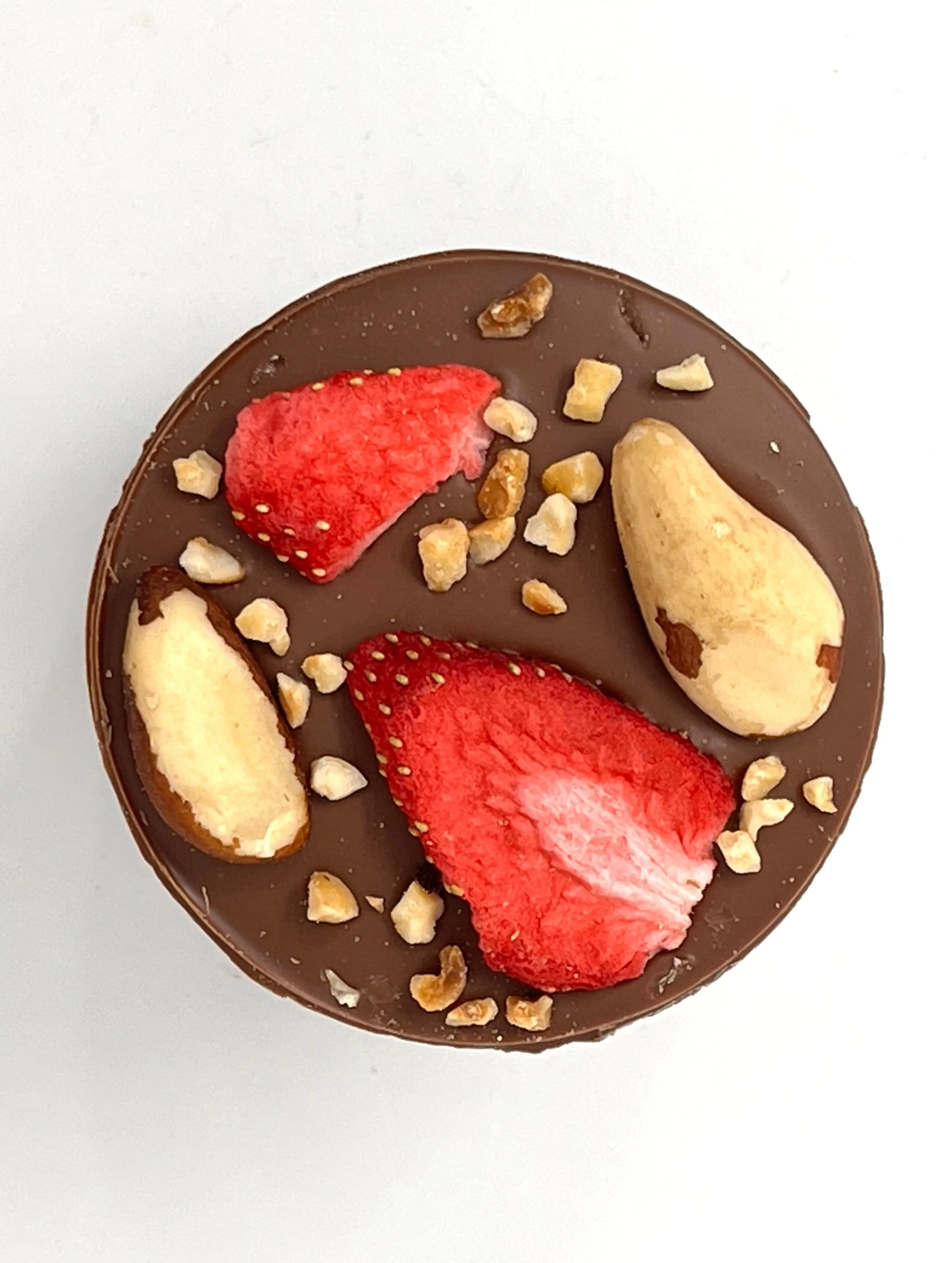 Gorvett & Stone handmade giant milk chocolate mendiant with assorted dried fruits and nuts on a white background.
