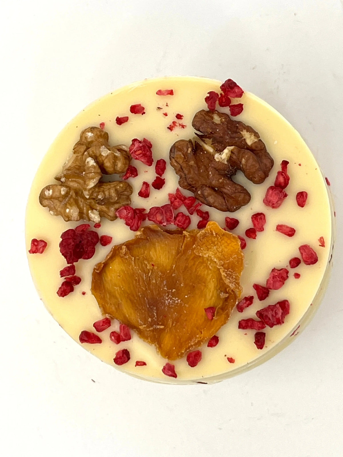 Handmade white chocolate giant mendiant with chocolate-covered fruits and nuts from Gorvett & Stone.