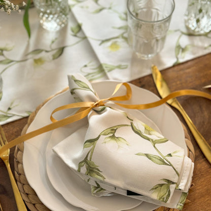 Pair of Avalon Home UK snowdrop and hellebore patterned napkins with floral design on soft fabric.