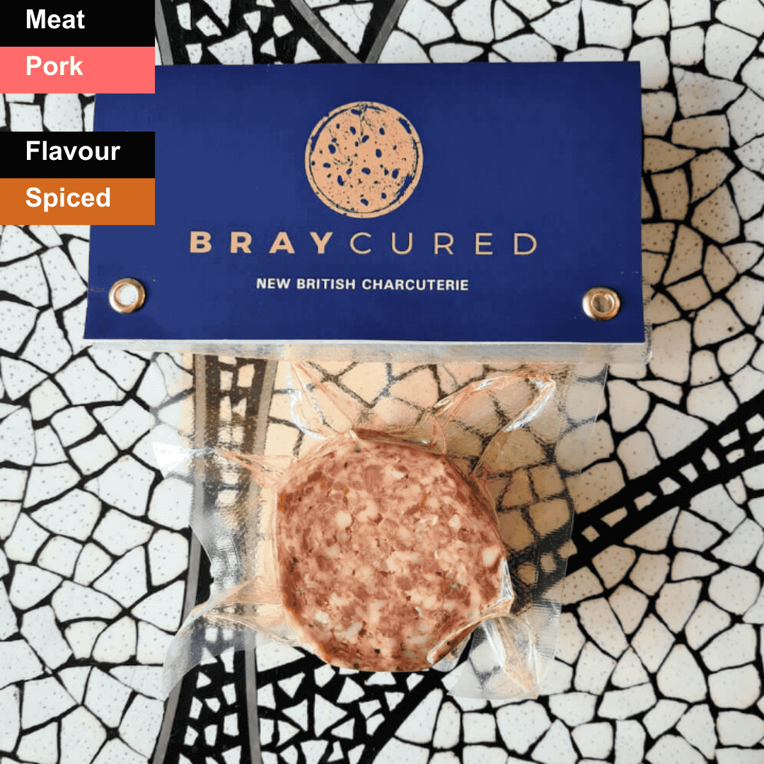 Spicy Bray Cured British 'Nduja spread on a wooden board, showcasing its vibrant red color and soft, spreadable texture.
