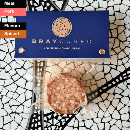 Spicy Bray Cured British 'Nduja spread on a wooden board, showcasing its vibrant red color and soft, spreadable texture.