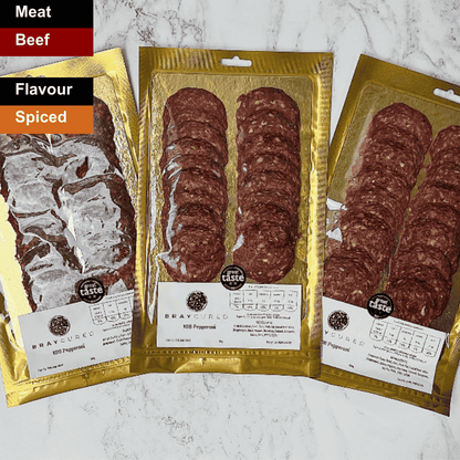 Spicy British Pepperoni slices from Bray Cured charcuterie displayed on a wooden board.