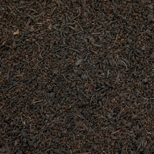 Loose leaf tea in a canister labeled St Pauls, A Fine London Breakfast Blend by High Teas, with tea leaves visible inside.