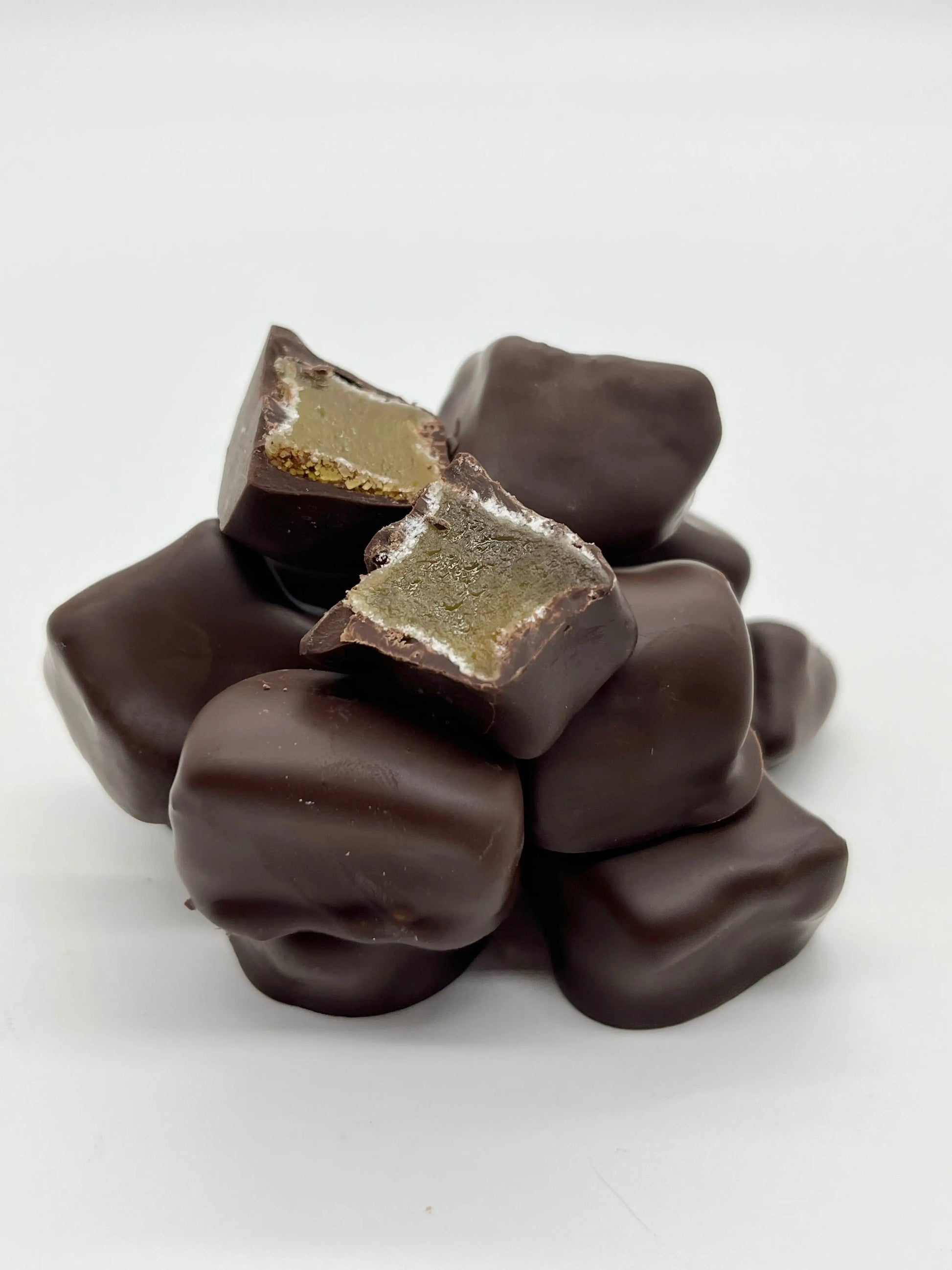 Gorvett & Stone stem ginger coated in 70% dark chocolate, presented in a close-up image showing the ginger and glossy chocolate coating.