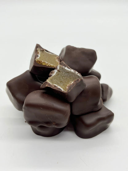 Gorvett & Stone stem ginger coated in 70% dark chocolate, presented in a close-up image showing the ginger and glossy chocolate coating.