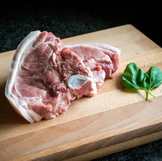 Fresh pork T-bone chops from Primrose Herd, showcasing juicy, bone-in pork chops with marbled meat and a clean, appetizing appearance.