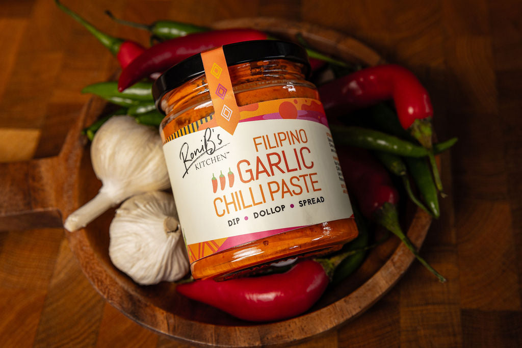 RoniBs Kitchen Filipino garlic chilli paste hot sauce with Scotch bonnets, medium heat, vegan-friendly, vibrant jar with chili peppers