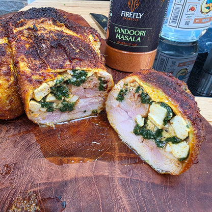FireFly Barbecue Tandoori Spice Seasoning BBQ rub on grilled chicken, showcasing vibrant red tandoori spice blend.