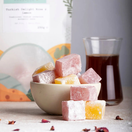 Turkish Delight with rose and lemon flavors by Whole Food Earth arranged on a plate with a floral background.