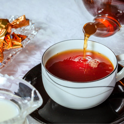 Assorted tea and infusion samples in a Camellios Tea Sampler Gift Set with colorful packaging and tea bags arranged neatly.
