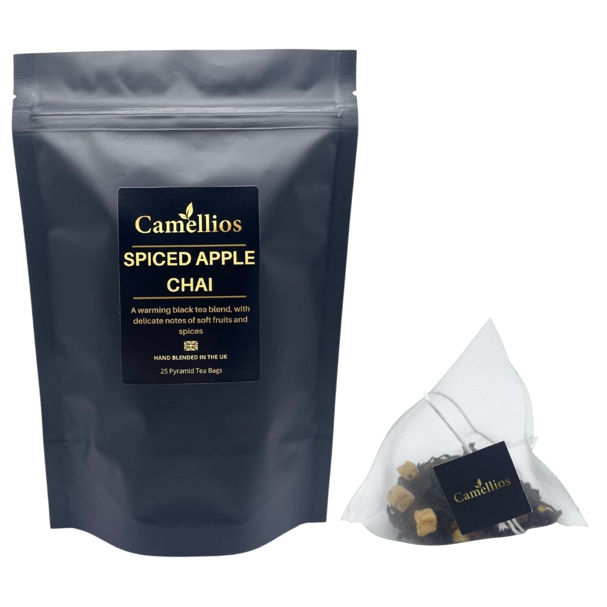 Camellios Spiced Apple Chai tea in a clear glass cup with cinnamon sticks and apple slices, highlighting warm, spiced infusion.