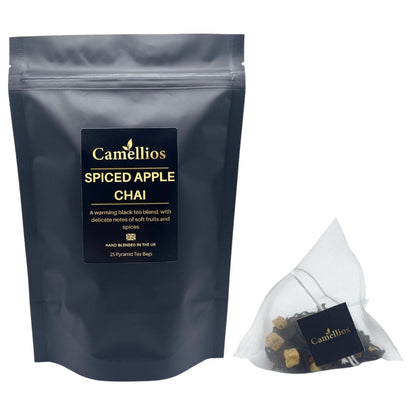 Camellios Spiced Apple Chai tea in a clear glass cup with cinnamon sticks and apple slices, highlighting warm, spiced infusion.