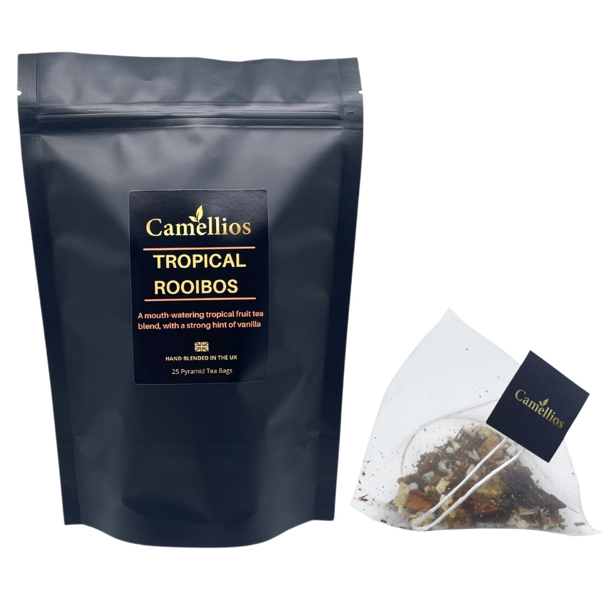 Camellios Tropical Rooibos tea in a glass cup with vibrant tropical fruits and leaves, showcasing a colorful tea infusion.