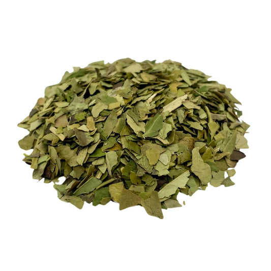 Loose leaf Yerba Mate tea from Camellios, with fresh green leaves and stems for traditional infusion and herbal flavor.