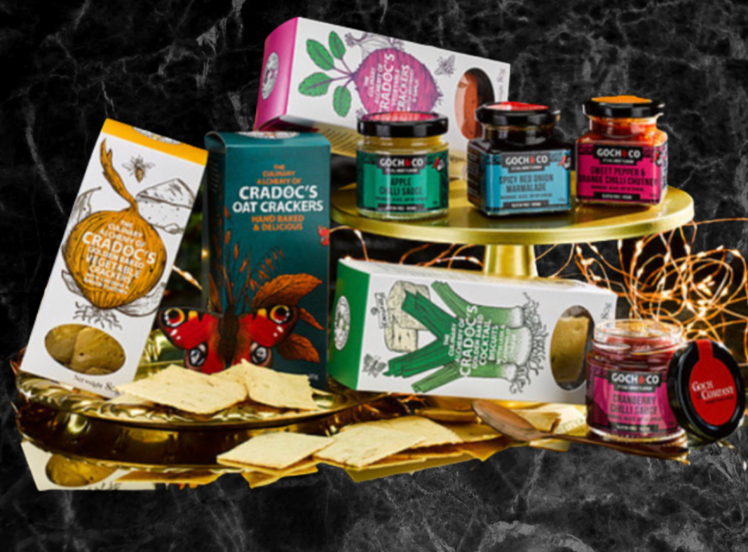 Assorted food items in a Goch & Co Celebration Hamper, featuring gourmet snacks, preserves, and delicacies arranged in a decorative basket.