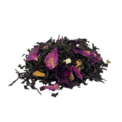 Box of Camellios Earl Grey tea and infusions with tea leaves and citrus slices on a rustic wooden surface.