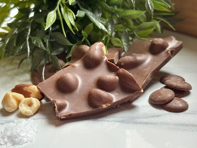 Handmade milk chocolate shards with a very nutty texture by Gorvett & Stone, showcasing the crunchy, nut-filled chocolate pieces.