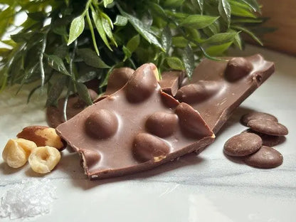 Handmade milk chocolate shards with a very nutty texture by Gorvett & Stone, showcasing the crunchy, nut-filled chocolate pieces.