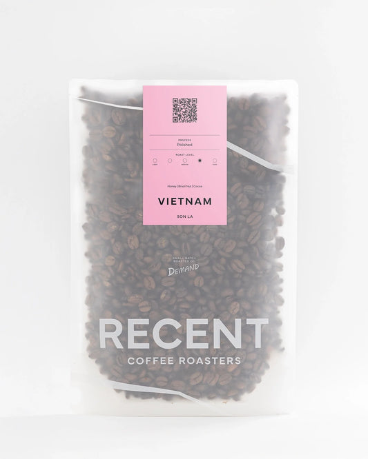 Recent Beans Son La G1 medium dark roast coffee bag with a label featuring Vietnamese coffee branding and rich dark roast color.