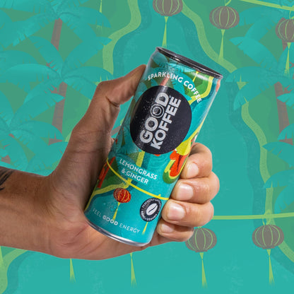 A hand holding a can of Good Koffee Sparkling Coffee Lemongrass & Ginger against a stylized tropical background.