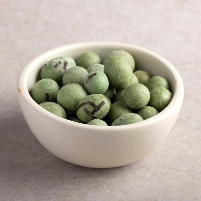 Crunchy wasabi peanuts by Whole Food Earth, specialty snack with spicy wasabi flavor and roasted peanut interior.