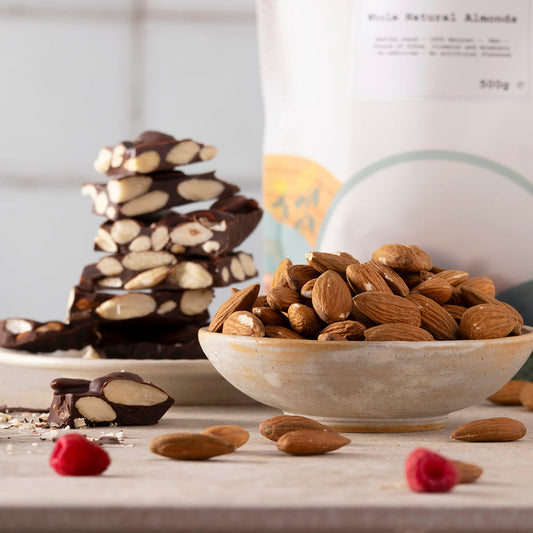 A bowl of whole natural almonds from Whole Food Earth, showcasing fresh, raw almonds in a natural setting.