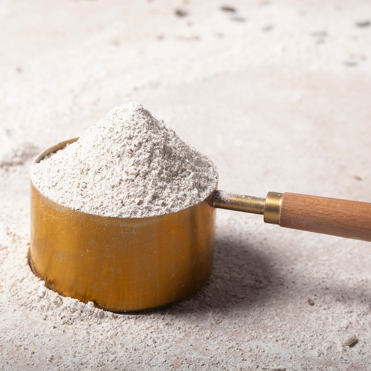 Wholemeal rye flour in a bag, stoneground, from Serious Grains by Whole Food Earth, showing the ingredient label and natural flour texture.
