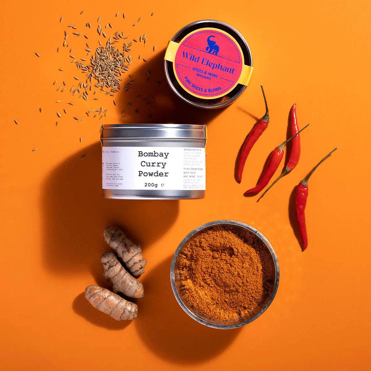 Wild Elephant Bombay Curry Powder from Whole Food Earth, a blend of spices in a colorful jar, ideal for flavorful Indian dishes.